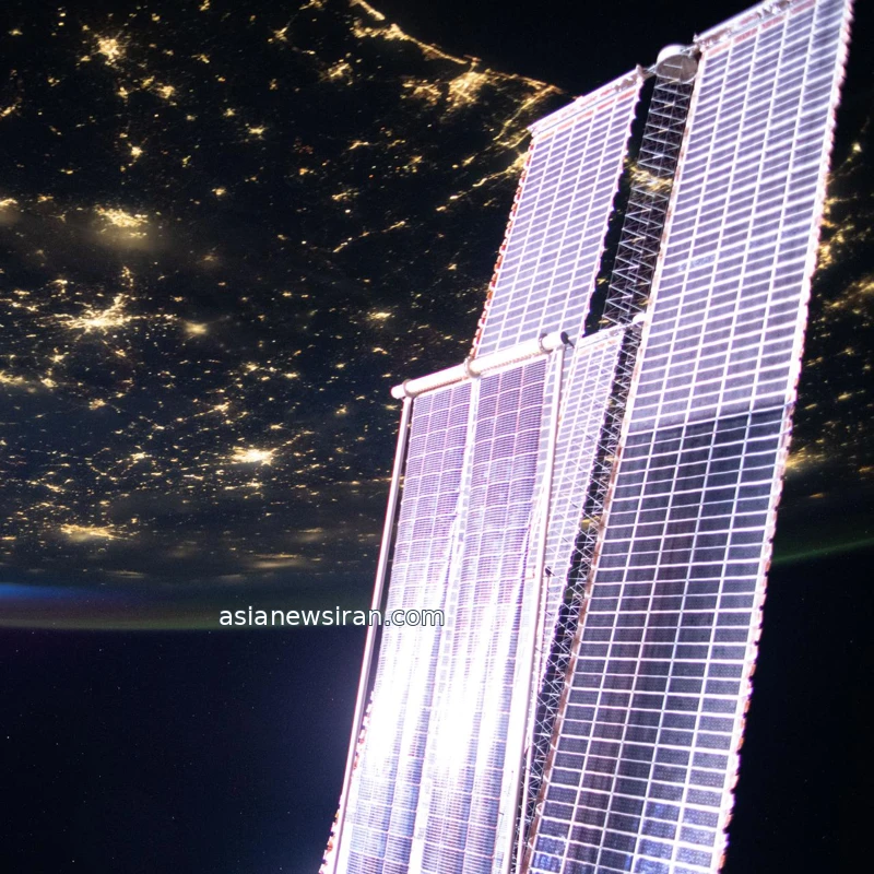 NASA archive view of existing ISS solar arrays above city lights on Earth